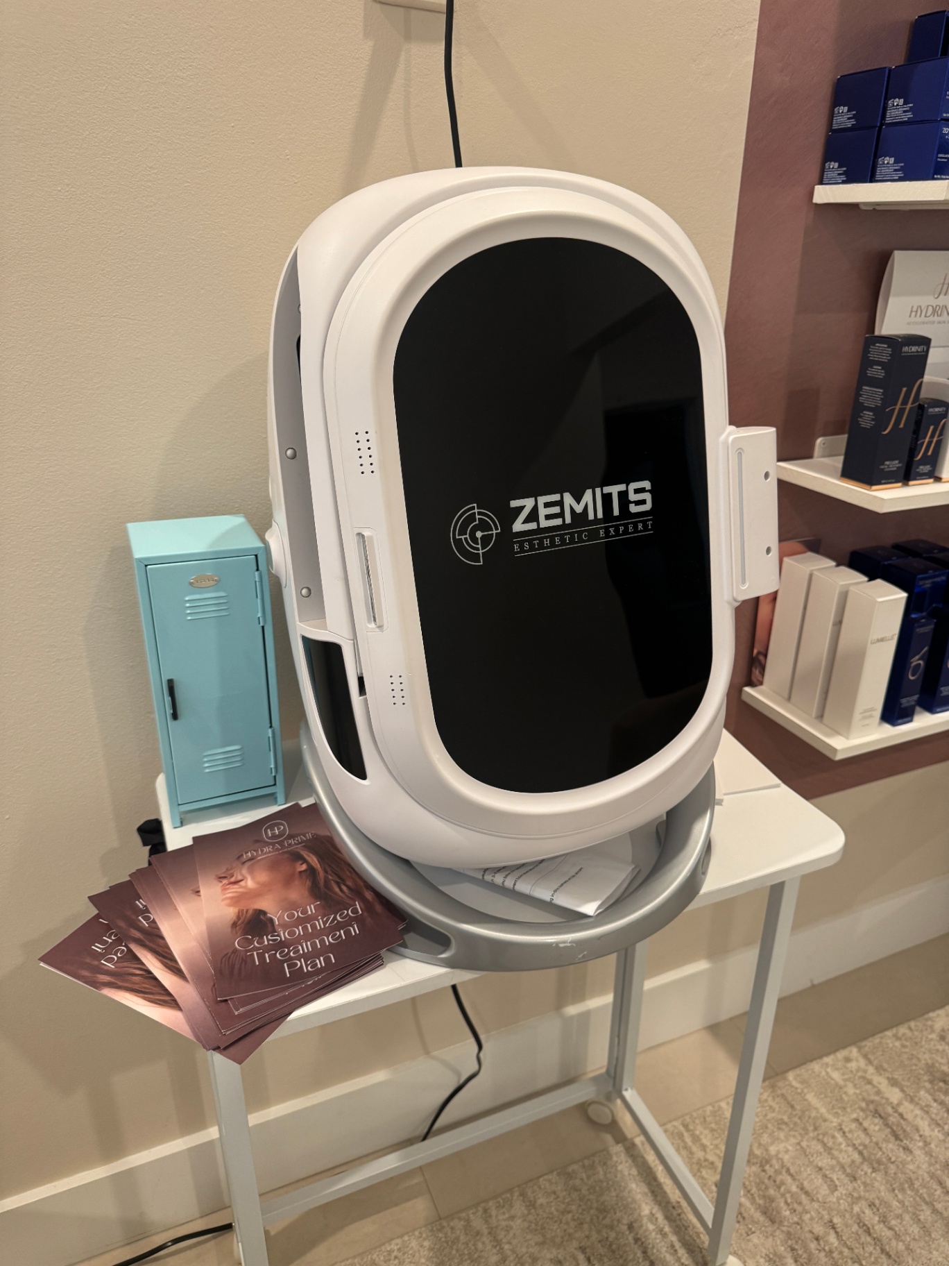 Zemits VeraFace scanner beside stack of customized treatment plan booklets